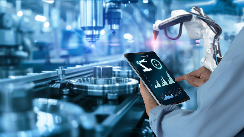 A person holding a tablet looking at automation controls